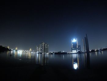 View of illuminated cityscape against sky at night
