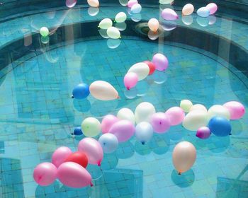 High angle view of balloons on glass above pavement