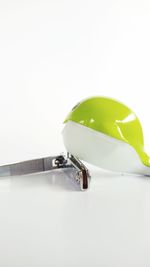 Close-up of spoon on table against white background