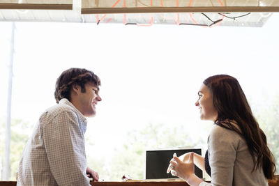 Friends sitting by window at coffee shop