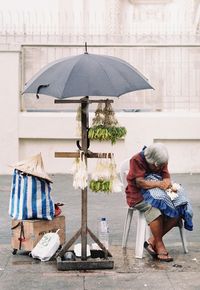 Full length of woman holding umbrella