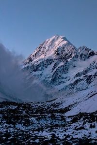 Scenic view of snowcapped mountains against clear sky