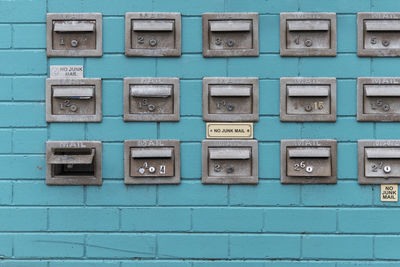 Full frame shot of mailboxes on blue wall