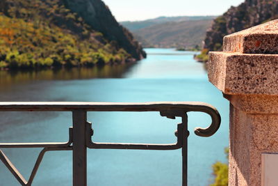 Close-up of metal railing by swimming pool in lake