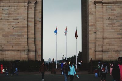Group of people against buildings in city