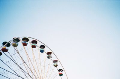 Low angle view of ferris wheel against clear sky