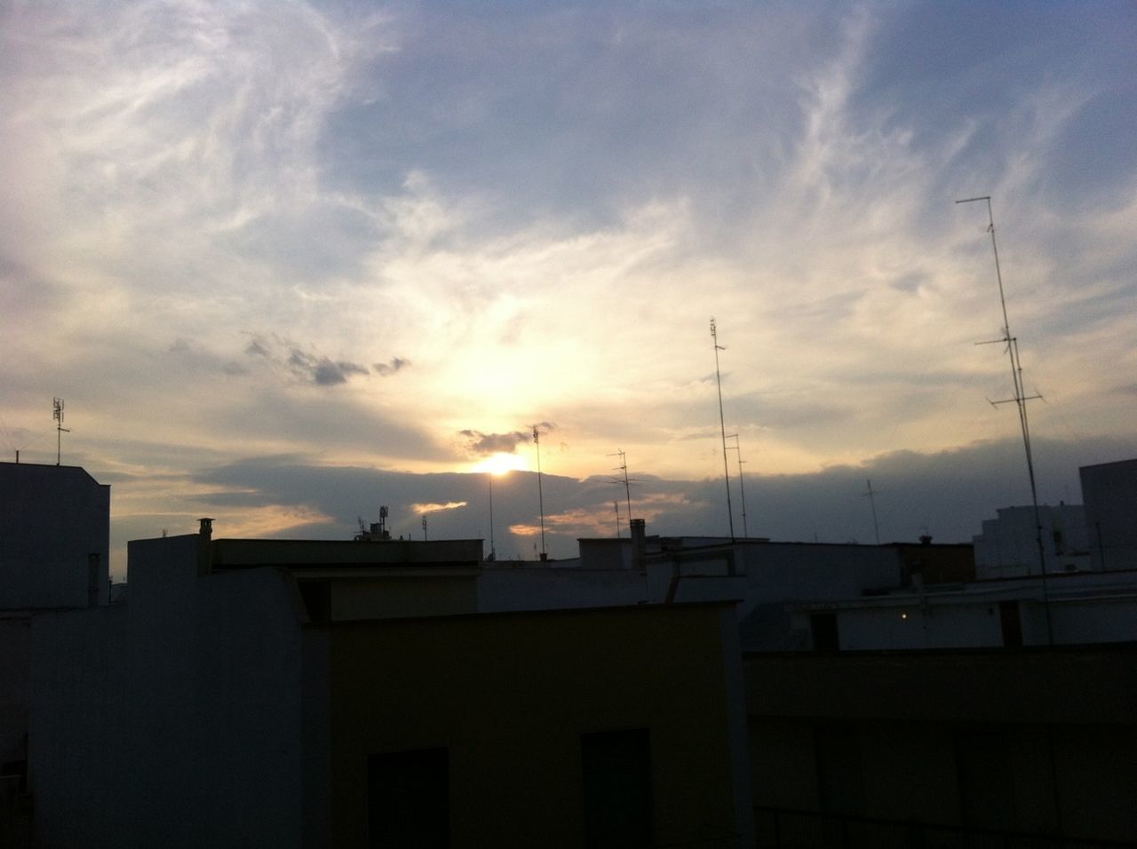 sunset, building exterior, architecture, sky, built structure, cloud - sky, sun, house, residential structure, cloud, cloudy, orange color, silhouette, residential building, sunlight, building, outdoors, city, no people, nature