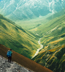 Rear view of man standing on mountain