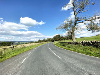 View along the, slaidburn road, with dry stone walls, fields, and trees in, newton, clitheroe, uk