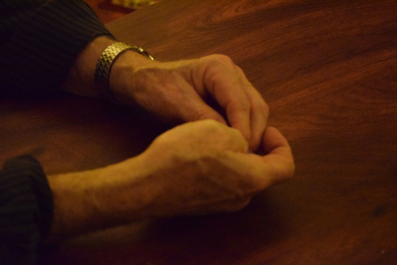 CLOSE-UP LOW SECTION OF MAN WITH HAND ON FLOOR