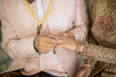 Midsection of bride with henna tattoo