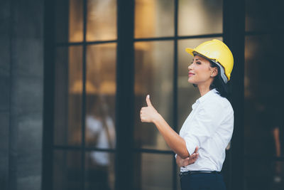 Side view of a young woman wearing hat