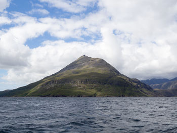 Scenic view of sea and mountains against sky