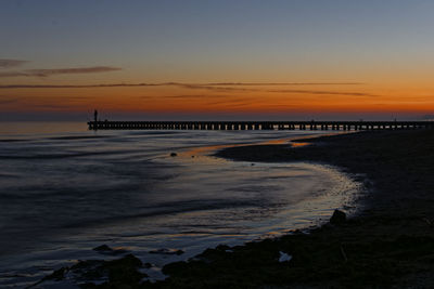 Scenic view of beach against sky during sunset