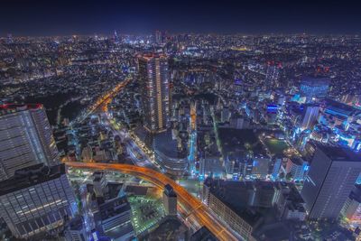 High angle view of illuminated city buildings at night