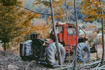 Abandoned cars on field during autumn