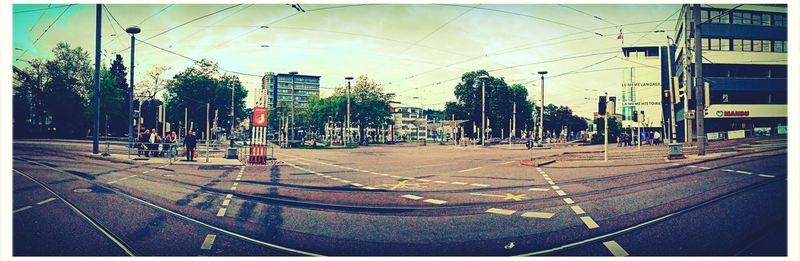 Empty road with buildings in background