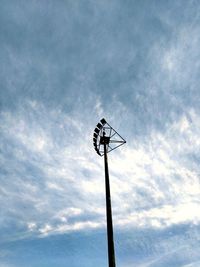 Low angle view of silhouette telephone pole against sky