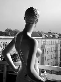 Close-up of girl standing against built structure