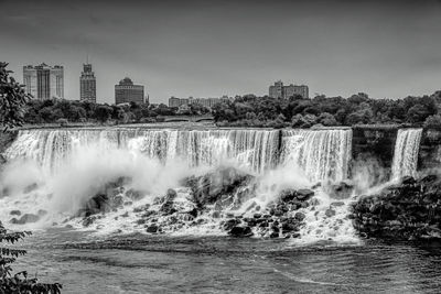 Water splashing in sea against buildings in city