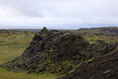 Rock formations on landscape against sky