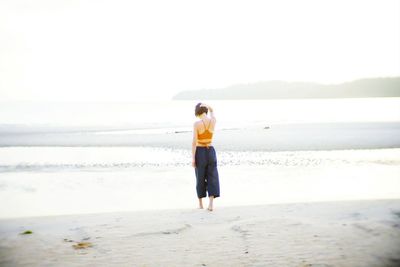 Rear view of man standing on beach