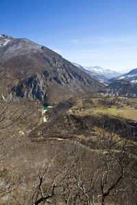Scenic view of mountains against blue sky