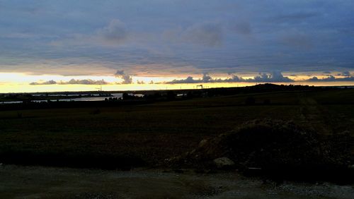 Scenic view of field against sky during sunset