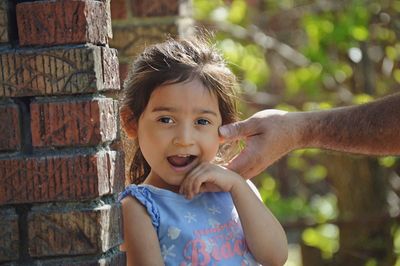 Cropped hand of man touching daughter