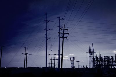 Low angle view of electricity pylon against sky