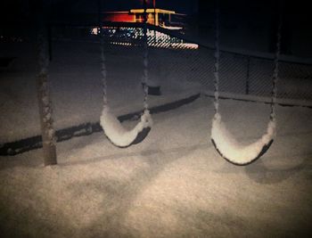 Illuminated electric lamp on street in city