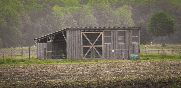 Built structure on field against trees