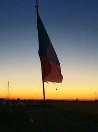 Close-up of flag against sky at sunset