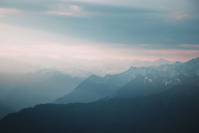 Scenic view of mountains against cloudy sky