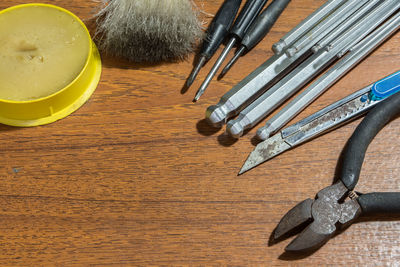 Close-up of metal tools on wooden table