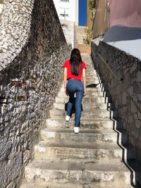 Full length of woman walking on staircase