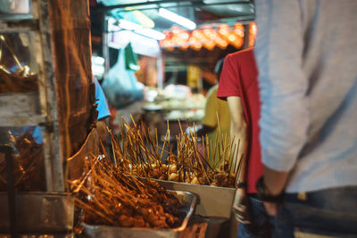 Close-up of man standing at market stall