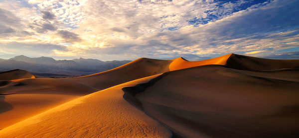 Scenic view of desert against sky during sunset