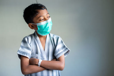 Boy standing against white background