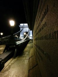 Illuminated tunnel at night