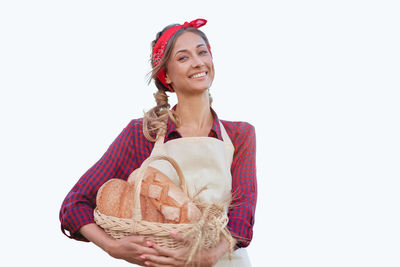 Portrait of a smiling young woman against white background