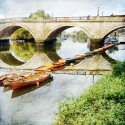 Bridge over river with buildings in background