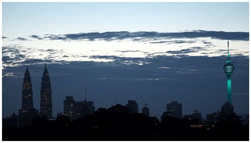 Skyscrapers against cloudy sky