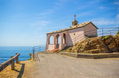 View of road by sea against sky