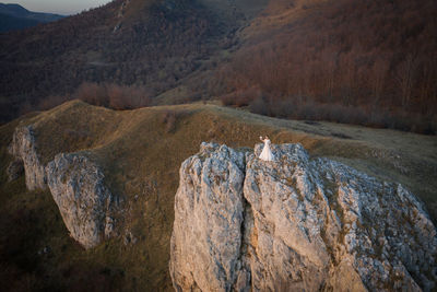 High angle view of bride standing on rock formation