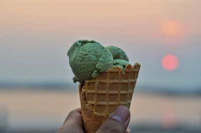 Close-up of hand holding ice cream cone