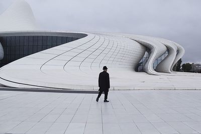 Rear view of man walking outside heydar aliyev center museum 