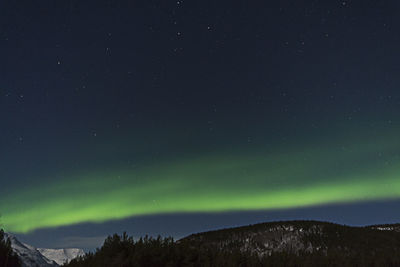 Northern lights over mountains at night