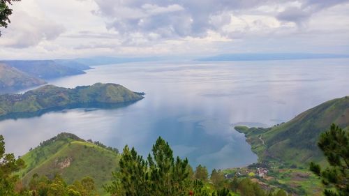 Scenic view of mountains against cloudy sky