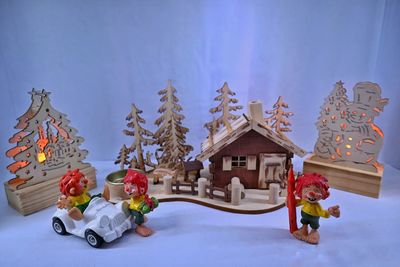 Small toy car on snow covered house by building during winter